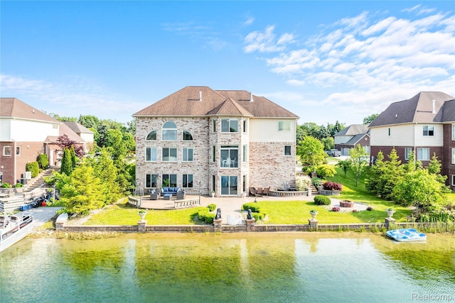 4303 S Lake Ln, Shelby Twp, MI 48316 - back of house featuring a water view, a patio, a yard, and a residential view