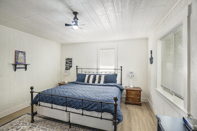 10520 Maple Xing, Canadian Lakes, MI 49346 - bedroom featuring light wood-style floors, crown molding, a ceiling fan, and wooden walls