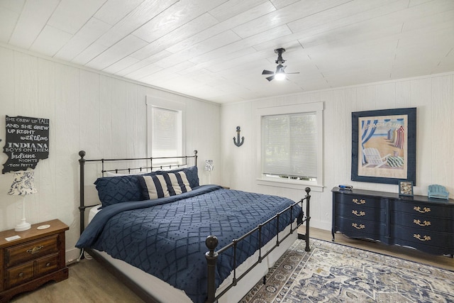 10520 Maple Xing, Canadian Lakes, MI 49346 - bedroom featuring wood finished floors, wooden walls, and ceiling fan