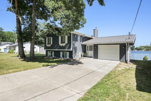 10520 Maple Xing, Canadian Lakes, MI 49346 - tri-level home with a garage, a chimney, driveway, and a front yard