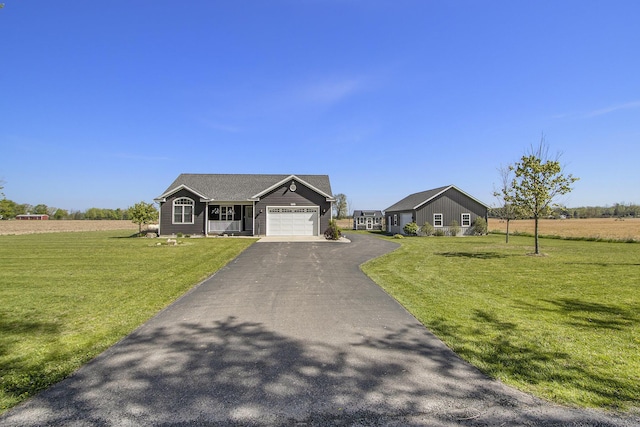 9733 E O Ave, Kalamazoo, MI 49048 - view of front of home with a garage, asphalt driveway, and a front yard