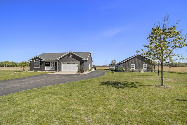 9733 E O Ave, Kalamazoo, MI 49048 - view of front of house featuring a garage, driveway, and a front lawn