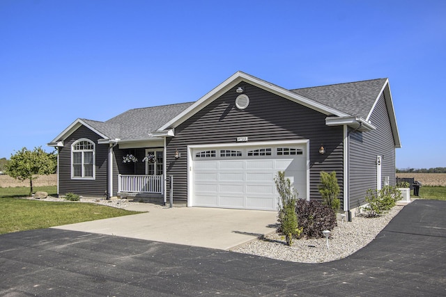 9733 E O Ave, Kalamazoo, MI 49048 - single story home featuring driveway, an attached garage, a shingled roof, and covered porch