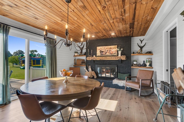 13451 S Waldron Rd, Waldron, MI 49288 - dining space with wooden ceiling, hardwood / wood-style flooring, a brick fireplace, and wooden walls