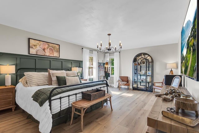13451 S Waldron Rd, Waldron, MI 49288 - bedroom featuring a chandelier and light wood-type flooring