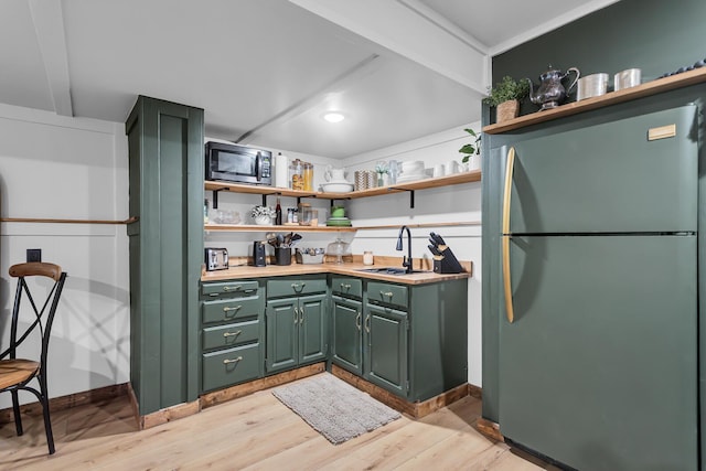 13451 S Waldron Rd, Waldron, MI 49288 - kitchen with stainless steel appliances, open shelves, green cabinetry, light wood finished floors, and light countertops