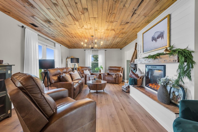 13451 S Waldron Rd, Waldron, MI 49288 - living room featuring a glass covered fireplace, wood ceiling, a chandelier, and light wood-style flooring
