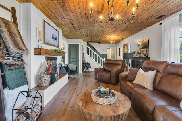 13451 S Waldron Rd, Waldron, MI 49288 - living room with stairs, wooden ceiling, a chandelier, a lit fireplace, and wood-type flooring