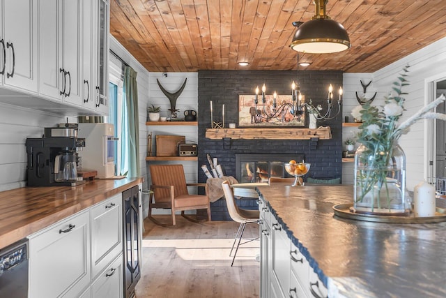13451 S Waldron Rd, Waldron, MI 49288 - kitchen with butcher block counters, wood ceiling, open shelves, white cabinetry, and a brick fireplace