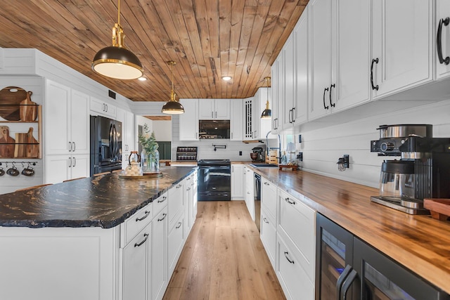13451 S Waldron Rd, Waldron, MI 49288 - kitchen featuring black appliances, wood ceiling, wood counters, white cabinetry, and a large island