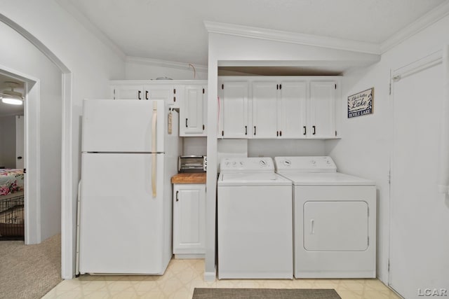5390 Parkwood Ct, Manitou Beach, MI 49253 - washroom with separate washer and dryer, ornamental molding, light flooring, and cabinet space