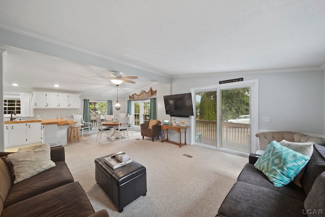 5390 Parkwood Ct, Manitou Beach, MI 49253 - living area with light carpet, crown molding, and a ceiling fan