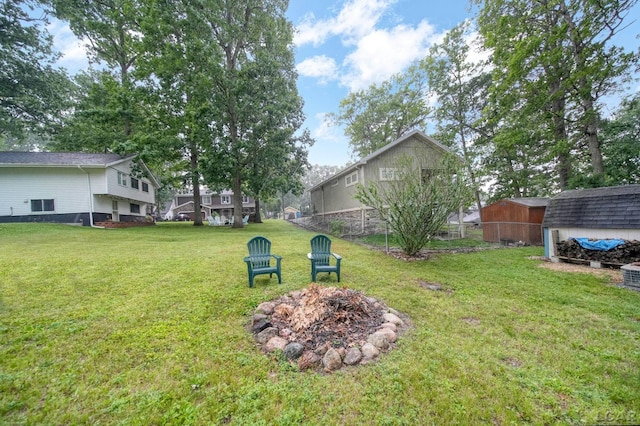 5390 Parkwood Ct, Manitou Beach, MI 49253 - view of yard featuring an outdoor fire pit and a storage unit