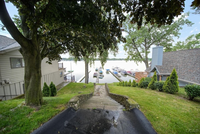 5390 Parkwood Ct, Manitou Beach, MI 49253 - view of green lawn featuring a water view and a dock