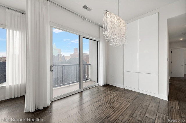 438 Selden St Unit 401, Detroit, MI 48201 - unfurnished dining area with a chandelier and dark wood-style flooring