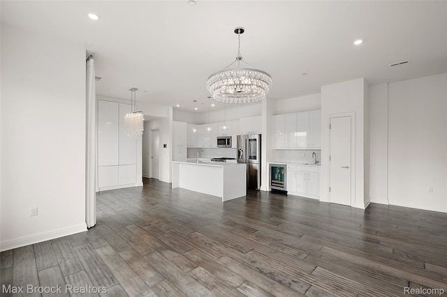 438 Selden St Unit 401, Detroit, MI 48201 - unfurnished living room featuring beverage cooler, a chandelier, dark wood finished floors, and recessed lighting