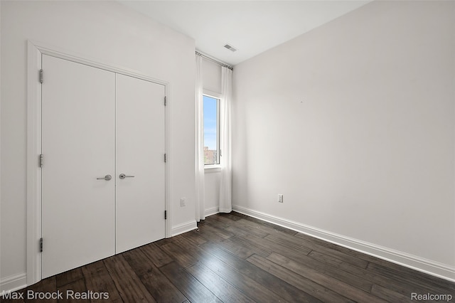 438 Selden St Unit 401, Detroit, MI 48201 - unfurnished bedroom featuring dark wood-type flooring and a closet