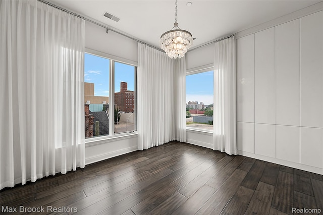 438 Selden St Unit 401, Detroit, MI 48201 - unfurnished dining area with a chandelier, dark wood-style flooring, and a city view