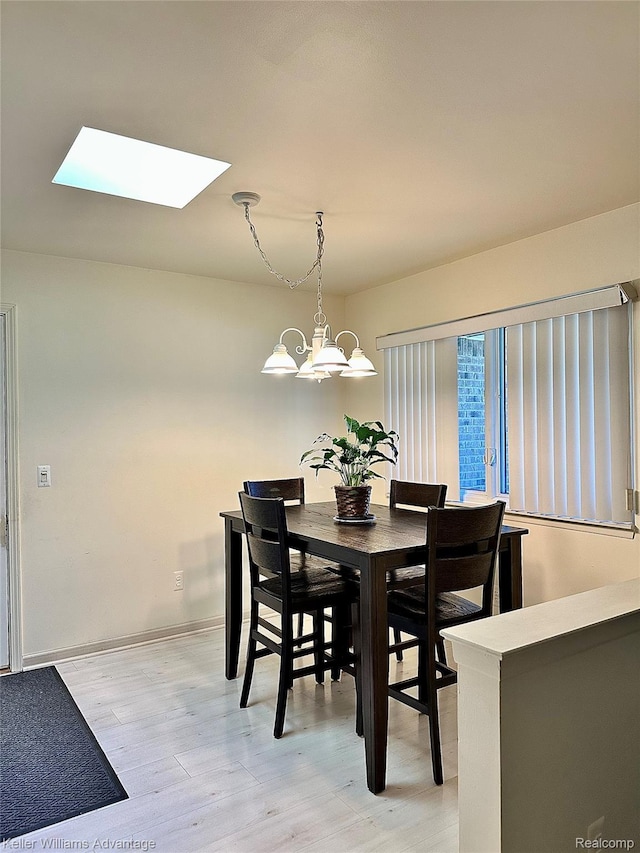 31441 Orchard Brook Ct, Farmington Hills, MI 48336 - dining room featuring a chandelier, a skylight, and light wood-style floors