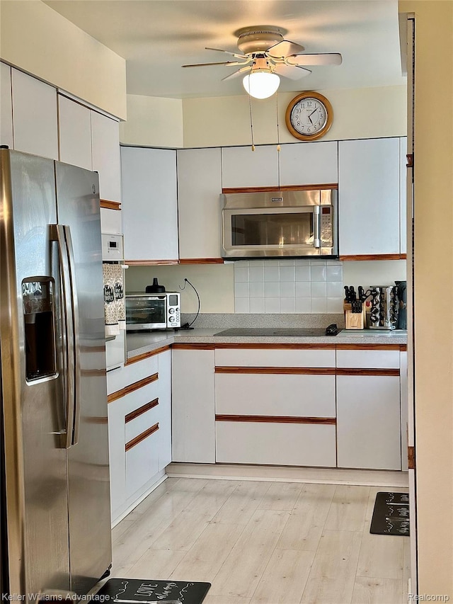 31441 Orchard Brook Ct, Farmington Hills, MI 48336 - kitchen featuring stainless steel appliances, a ceiling fan, white cabinetry, backsplash, and light wood-style flooring