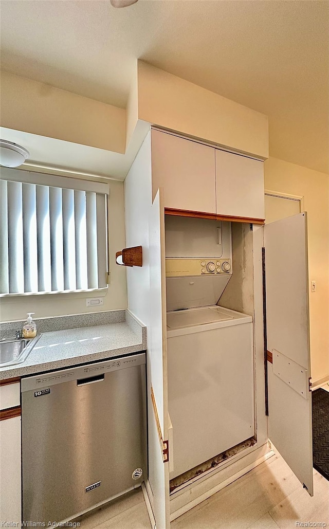 31441 Orchard Brook Ct, Farmington Hills, MI 48336 - kitchen featuring dishwasher, stacked washer and clothes dryer, light countertops, and white cabinets