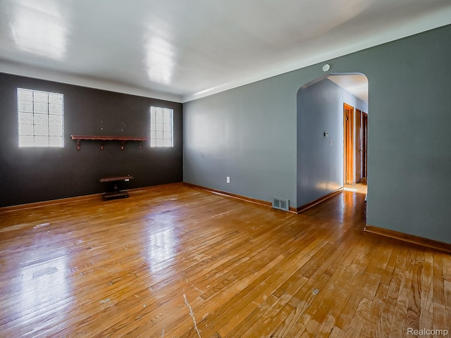 16039 Fordham St, Detroit, MI 48205 - empty room with arched walkways and wood-type flooring