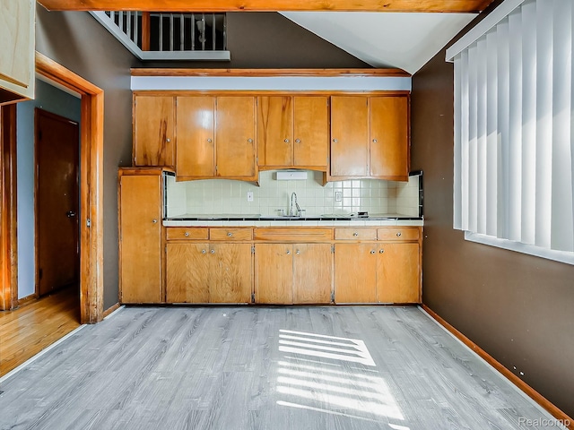16039 Fordham St, Detroit, MI 48205 - kitchen with light wood-type flooring, tasteful backsplash, vaulted ceiling, and brown cabinets