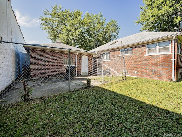 16039 Fordham St, Detroit, MI 48205 - rear view of property featuring brick siding, a patio area, and a shingled roof