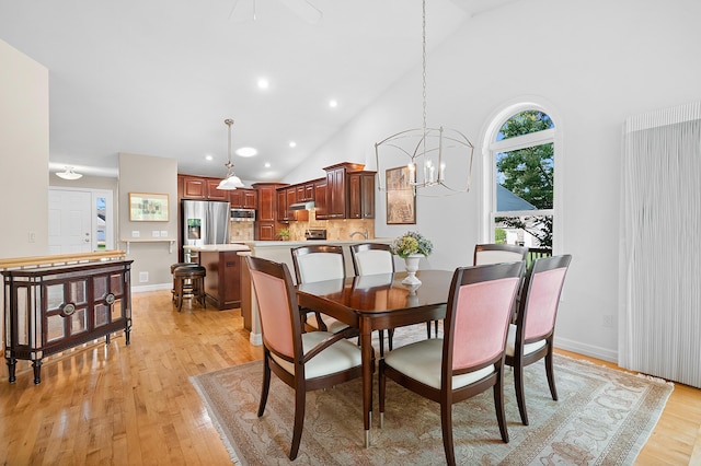 3229 Nighthawk Ln, Battle Creek, MI 49015 - dining space with high vaulted ceiling, light wood-type flooring, a chandelier, and recessed lighting