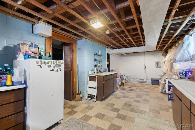 1044 Michigan Ave, Adrian, MI 49221 - unfinished below grade area featuring freestanding refrigerator and light flooring