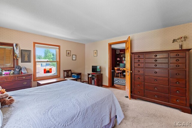 1044 Michigan Ave, Adrian, MI 49221 - bedroom with wallpapered walls, light colored carpet, and a desk