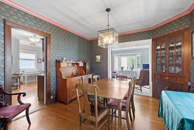 1044 Michigan Ave, Adrian, MI 49221 - dining room featuring wood finished floors, crown molding, and a chandelier