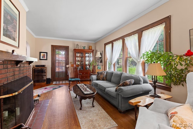 1044 Michigan Ave, Adrian, MI 49221 - living room featuring ornamental molding, a brick fireplace, and dark wood-type flooring