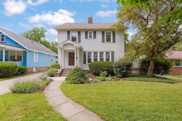 1044 Michigan Ave, Adrian, MI 49221 - view of front facade featuring a chimney and a front yard