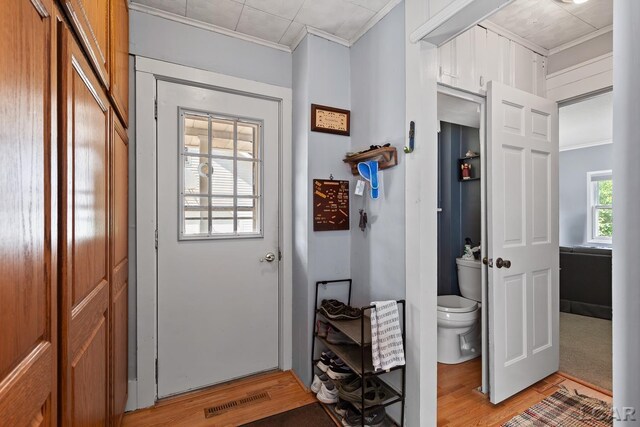 1044 Michigan Ave, Adrian, MI 49221 - doorway with crown molding and light wood-style floors
