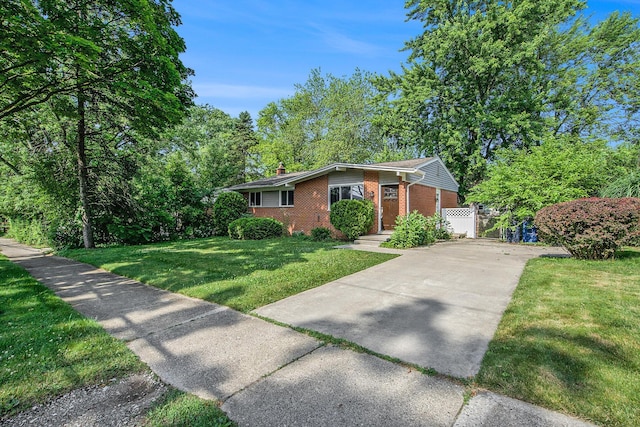 2375 Pontiac Trl, Ann Arbor, MI 48105 - ranch-style house featuring brick siding, driveway, a chimney, and a front lawn