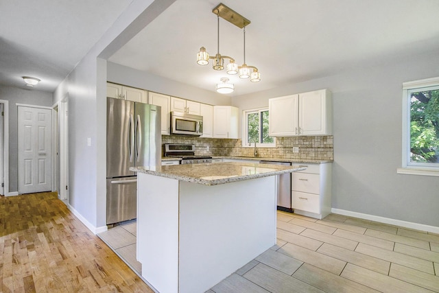 2375 Pontiac Trl, Ann Arbor, MI 48105 - kitchen featuring stainless steel appliances, light wood finished floors, and tasteful backsplash