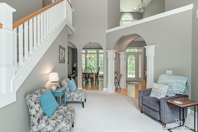 5264 Deverman Ct NE, Lowell, MI 49331 - sitting room with arched walkways, carpet, decorative columns, a high ceiling, and stairs