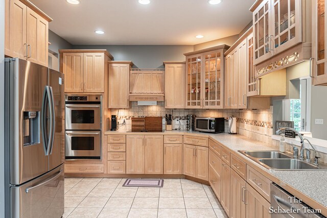 5264 Deverman Ct NE, Lowell, MI 49331 - kitchen with stainless steel appliances, premium range hood, light brown cabinetry, light countertops, and recessed lighting