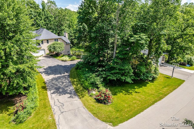5264 Deverman Ct NE, Lowell, MI 49331 - view of front of home featuring driveway, a front lawn, and a chimney