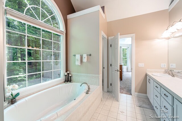 5264 Deverman Ct NE, Lowell, MI 49331 - full bathroom featuring vanity, a garden tub, plenty of natural light, and vaulted ceiling