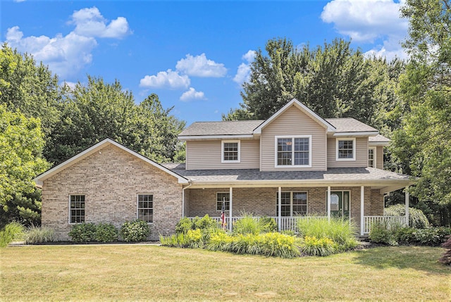 4166 Grandwood Cir, Saint Joseph, MI 49085 - traditional-style home with brick siding, a front lawn, a porch, and a shingled roof