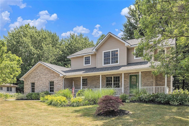 4166 Grandwood Cir, Saint Joseph, MI 49085 - traditional home featuring brick siding, a front lawn, covered porch, and roof with shingles