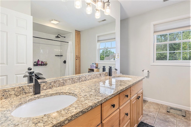 4166 Grandwood Cir, Saint Joseph, MI 49085 - bathroom featuring a shower, double vanity, and tile patterned flooring