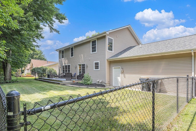 4166 Grandwood Cir, Saint Joseph, MI 49085 - rear view of house with a fenced backyard, a wooden deck, and a shingled roof