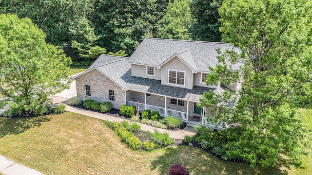 4166 Grandwood Cir, Saint Joseph, MI 49085 - view of front facade featuring covered porch, a front yard, and roof with shingles