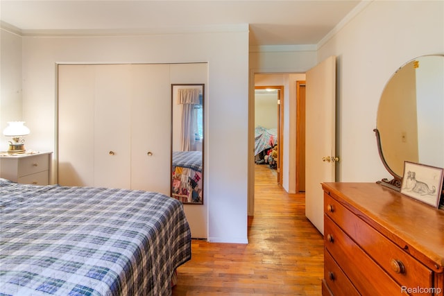 9892 Wheeler St, Van Buren, MI 48111 - bedroom with light wood-type flooring, crown molding, and a closet