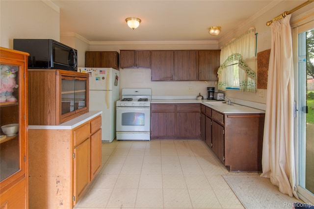 9892 Wheeler St, Van Buren, MI 48111 - kitchen featuring white appliances, light countertops, crown molding, brown cabinets, and light floors