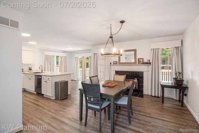 3708 Eaton Gate Ln, Auburn Hills, MI 48326 - dining space featuring a chandelier, wood finished floors, a high end fireplace, and recessed lighting