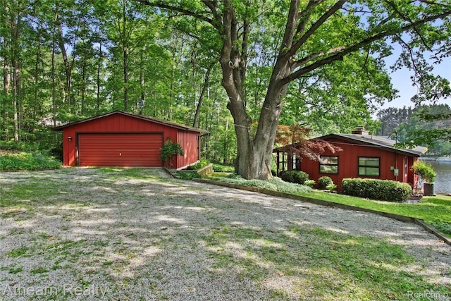 6600 W Shore Dr, Weidman, MI 48893 - view of yard featuring an outbuilding and a garage